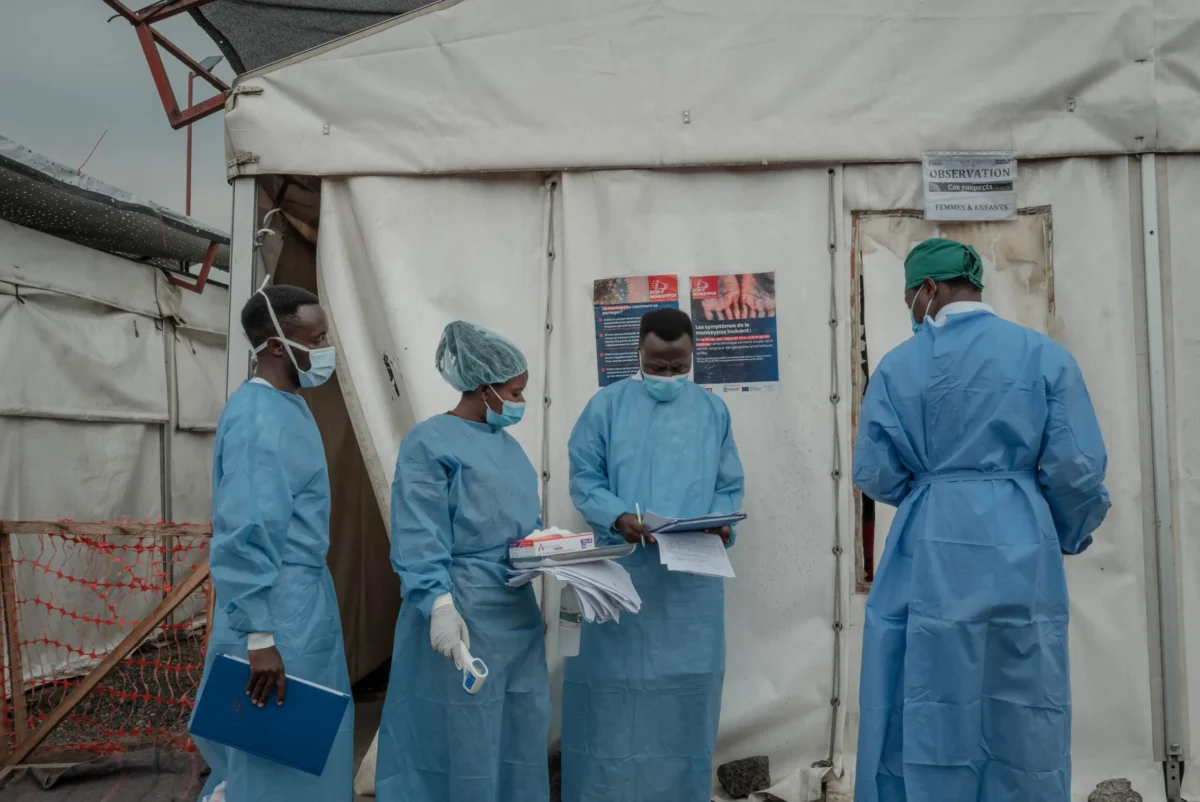 India's preparedness against Mpox illustrated by healthcare workers conducting surveillance and strategic reviews at a high-level meeting.