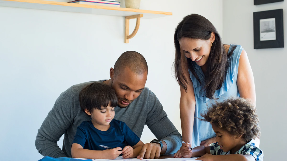 Child with attention deficit hyperactivity disorder (ADHD) concentrating on homework with supportive parent nearby.